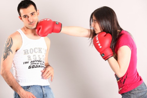 Vrouw die man met bokshandschoenen gaat slaan op gezicht